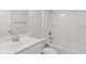 All-white bathroom featuring shower-tub combo, toilet, and vanity sink at 488 Village Ln, Fairburn, GA 30213