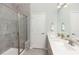 Modern bathroom featuring a glass-enclosed shower, double vanity, and neutral tile at 488 Village Ln, Fairburn, GA 30213
