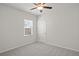Bedroom features neutral carpet, walls, and ceiling fan at 488 Village Ln, Fairburn, GA 30213