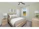 Cozy bedroom with a wood frame bed, neutral decor, and a window offering a view of the outdoors at 488 Village Ln, Fairburn, GA 30213