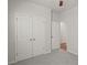 Bedroom with gray carpet, ceiling fan, and double door closet at 488 Village Ln, Fairburn, GA 30213