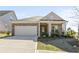 Charming brick single-Gathering home with a two-car garage and manicured lawn at 488 Village Ln, Fairburn, GA 30213