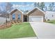 Charming brick home with well-manicured lawn and a two-car garage at 488 Village Ln, Fairburn, GA 30213