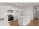 Modern kitchen features white cabinets, stainless steel appliances, and a central island at 488 Village Ln, Fairburn, GA 30213