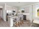 Well-lit kitchen with stainless steel appliances and granite countertops, complemented by stylish bar seating at 488 Village Ln, Fairburn, GA 30213
