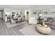 Open-concept living room with modern decor, includes kitchen, dining area, and living space at 488 Village Ln, Fairburn, GA 30213