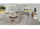 Bright, open-concept living area with a dining table, comfortable seating, and large windows showcasing the outdoors at 488 Village Ln, Fairburn, GA 30213