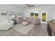 Inviting living room featuring a large sectional sofa, stylish decor, and expansive windows overlooking the backyard at 488 Village Ln, Fairburn, GA 30213