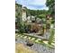 Backyard landscaping including a stone path and colorful flowers at 3809 Autumn View Nw Ln, Acworth, GA 30101