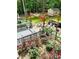 Expansive backyard showcasing a pergola, multiple seating areas, lush gardens, and an outdoor shed at 3809 Autumn View Nw Ln, Acworth, GA 30101