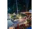 Nighttime view of the backyard highlighting a beautifully lit pergola, multiple seating areas, and vibrant garden at 3809 Autumn View Nw Ln, Acworth, GA 30101
