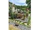 Well landscaped backyard with garden lights, bushes with red blooms, and a deck at 3809 Autumn View Nw Ln, Acworth, GA 30101