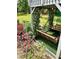 Cozy backyard with a covered swing, flower garden, and lush greenery at 3809 Autumn View Nw Ln, Acworth, GA 30101