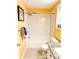 Bathroom featuring a shower-tub combination, white tile, and yellow walls at 3809 Autumn View Nw Ln, Acworth, GA 30101