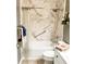 Bathroom features a marble-look shower, white fixtures, and updated hardware, offering both style and accessibility at 3809 Autumn View Nw Ln, Acworth, GA 30101