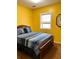 Cozy bedroom with a comfortable bed and warm yellow walls at 3809 Autumn View Nw Ln, Acworth, GA 30101