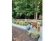 Back deck with seating and a raised garden bed full of yellow flowers at 3809 Autumn View Nw Ln, Acworth, GA 30101