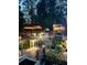 Evening view of a well-lit, multi-level deck with seating, and a beautiful outdoor setting at 3809 Autumn View Nw Ln, Acworth, GA 30101