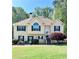 Charming two-story home with a well-manicured lawn, lush landscaping, and welcoming entrance stairs at 3809 Autumn View Nw Ln, Acworth, GA 30101