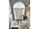 Inviting foyer with a decorative rug, flowers, and a staircase with wood railings, lit by an arched window at 3809 Autumn View Nw Ln, Acworth, GA 30101