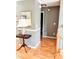 Hallway with wood floors, white trim, and a decorative lamp on a table, leading to other rooms in the house at 3809 Autumn View Nw Ln, Acworth, GA 30101