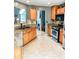 Well-lit kitchen featuring oak cabinets, granite countertops, stainless steel appliances, and tile floors at 3809 Autumn View Nw Ln, Acworth, GA 30101