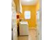 Well lit laundry room featuring yellow walls, white cabinets, and a washer and dryer at 3809 Autumn View Nw Ln, Acworth, GA 30101