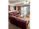 Comfortable living room features a leather sofa, glass top coffee table, and sliding glass doors to the backyard at 3809 Autumn View Nw Ln, Acworth, GA 30101