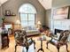 Cozy living room with hardwood floors, fireplace, and large window providing natural light at 3809 Autumn View Nw Ln, Acworth, GA 30101