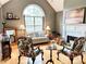 Bright living room with hardwood floors, fireplace, large arched window and elegant furnishings at 3809 Autumn View Nw Ln, Acworth, GA 30101