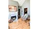 Cozy living room featuring hardwood floors, fireplace, and a view into the connecting kitchen area at 3809 Autumn View Nw Ln, Acworth, GA 30101
