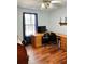 Office features a large wooden desk, wood floors, and bright natural light from the window with blue curtains at 3809 Autumn View Nw Ln, Acworth, GA 30101