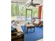 Cozy sunroom with wicker furniture, ceiling fan, and serene views of the wooded backyard at 3809 Autumn View Nw Ln, Acworth, GA 30101