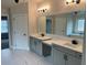 Dual vanity bathroom with framed mirrors, white countertops, and light gray cabinetry at 4015 Sierra Vista Cir, Cumming, GA 30040