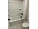 Bright bathroom featuring a bathtub with a shower and white tile at 4015 Sierra Vista Cir, Cumming, GA 30040