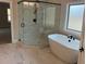 Modern bathroom featuring a freestanding tub, glass-enclosed shower, and marble flooring at 4015 Sierra Vista Cir, Cumming, GA 30040