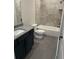 Modern bathroom featuring granite countertops, tiled walls, and a shower-tub combo at 4015 Sierra Vista Cir, Cumming, GA 30040