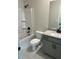 Bright bathroom featuring a shower-tub combo, toilet, and single sink vanity with a light gray cabinet at 4015 Sierra Vista Cir, Cumming, GA 30040