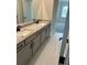 Bathroom featuring a dual sink vanity with granite countertops and tiled floors at 4015 Sierra Vista Cir, Cumming, GA 30040