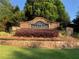 Landscaped brick entrance to Sierra Lake community with shrubbery and manicured lawn at 4015 Sierra Vista Cir, Cumming, GA 30040