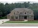 Beautiful brick two-story home featuring a landscaped front yard and attached two-car garage at 4015 Sierra Vista Cir, Cumming, GA 30040
