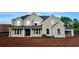 A stately two-story home featuring a brick facade, grey accents, and a charming covered front porch at 4015 Sierra Vista Cir, Cumming, GA 30040