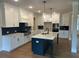 Modern kitchen with white cabinets, a center island with bar seating, and stainless steel appliances at 4015 Sierra Vista Cir, Cumming, GA 30040