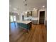 A kitchen featuring a kitchen island, pendant lighting, stainless steel appliances, and open access to the backyard at 4015 Sierra Vista Cir, Cumming, GA 30040