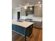 Stylish kitchen with a large island, stainless steel appliances, modern cabinetry, and a sleek range hood at 4015 Sierra Vista Cir, Cumming, GA 30040