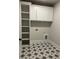 Well-organized laundry room with patterned tile floors, built-in shelving, and ample storage space at 4015 Sierra Vista Cir, Cumming, GA 30040