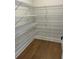 Bright walk-in closet featuring wire shelving and hardwood floors at 4015 Sierra Vista Cir, Cumming, GA 30040
