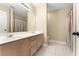 Bright bathroom with a double sink vanity, tile flooring, and a well-lit mirror at 4572 Mulberry Fields Ln, Auburn, GA 30011