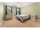 Relaxing bedroom featuring a comfortable armchair, natural light, and a ceiling fan for added comfort at 4572 Mulberry Fields Ln, Auburn, GA 30011