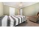 Comfortable bedroom featuring neutral tones, a ceiling fan, and a cozy armchair for relaxation at 4572 Mulberry Fields Ln, Auburn, GA 30011